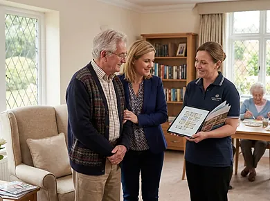 Older couple discussing future care arrangements with an adviser at home.